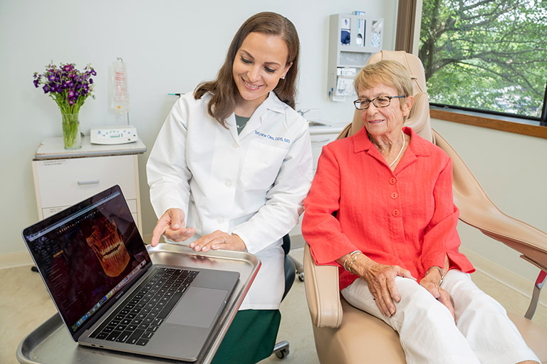 Doctor using technology to show her patient her x-rays